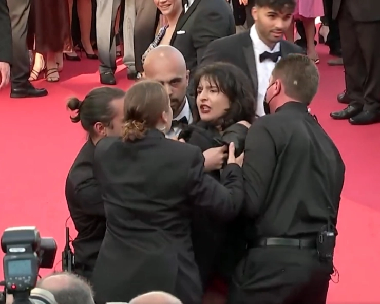 Topless, screaming woman crashes Cannes red carpet to protest war