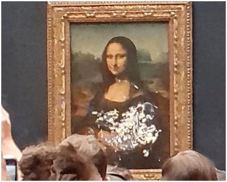 WATCH - Man disguised as an old woman in wheelchair throws cake at Mona Lisa