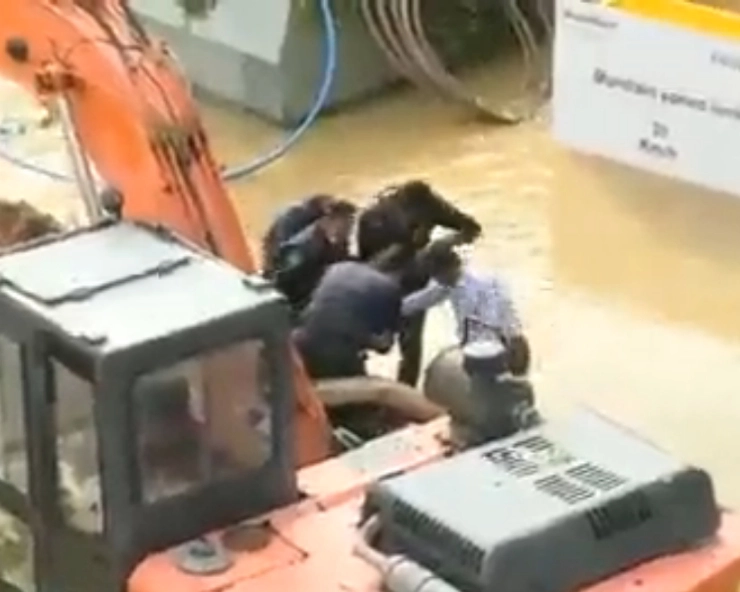 WATCH - Waterlogging puts Bengaluru out of gear, security guards rescue man stuck on waterlogged road