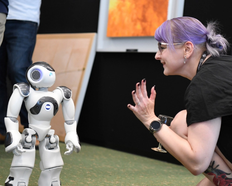 A participant interacts with a robot developed by United Robotics Group at AI for Good Global Summit in Geneva, Switzerland