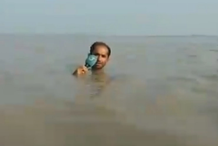 बाढ़ के पानी में गले तक डूबा रिर्पोटर, सोशल मीडिया पर वायरल हुआ वीडियो - reporter in flood water, video gets viral on social media