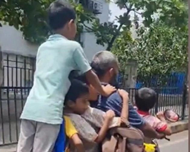 man carries 7 children on scooter