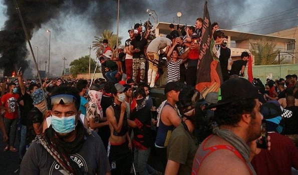 Iraqi forces kill 13 protesters, deploy military to stem unrest