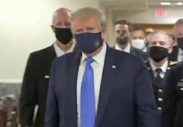 Trump wears mask on camera for first time as he visits military hospital