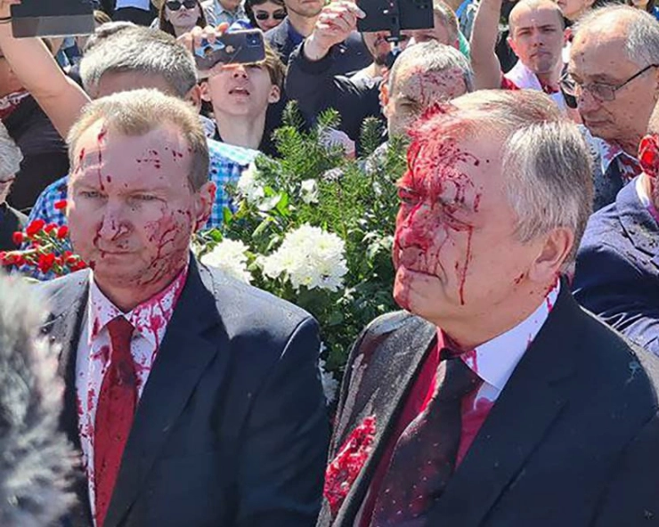 WATCH - Russian envoy to Poland splattered by red paint in war protest