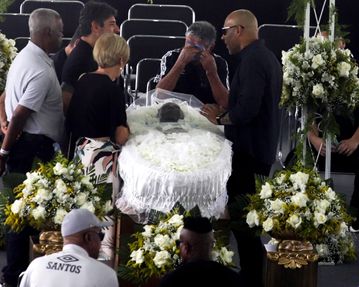Pele laid to rest as mourners gather for the football 'king'