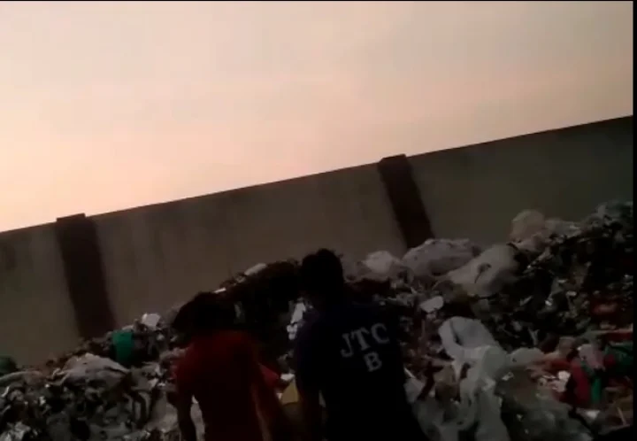 Tractor dumps garbage on woman