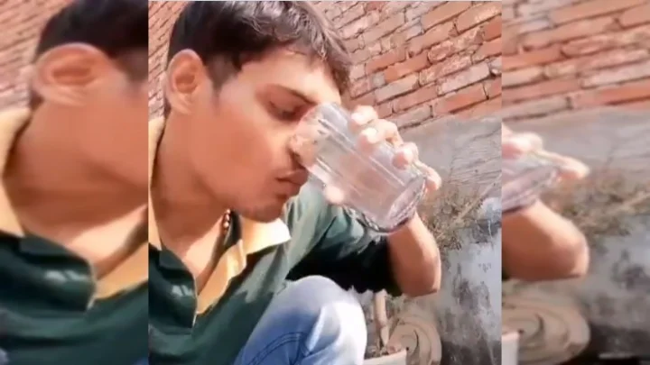 Bizarre young man drinking water